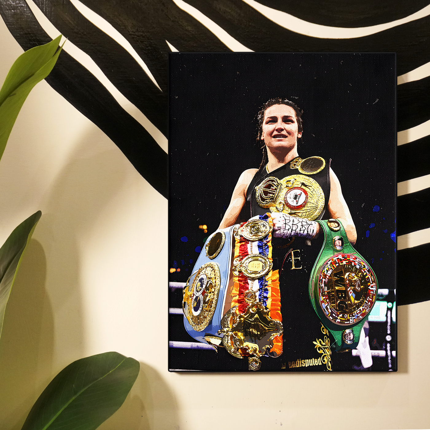 Boxer Katie Taylor holding her championship belts